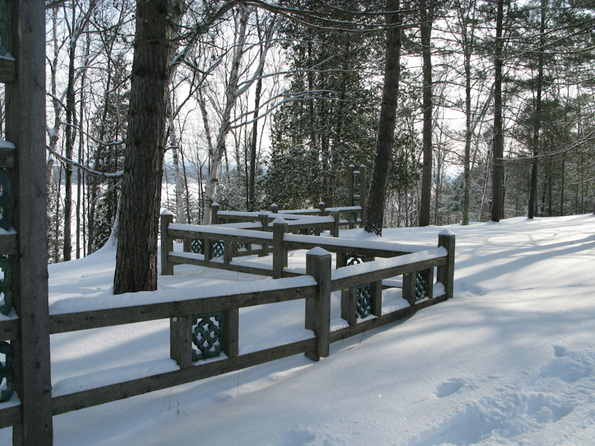 A low fence separates a picnic area from the larger meadow.