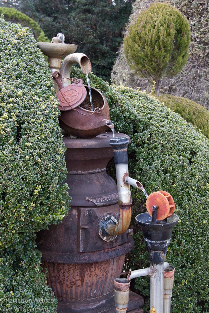 A fountain made of recycled materials features an old pot bellied stove, a kettle and various bits and pieces that Fryar found.
