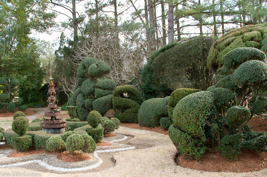 One corner of the garden contains unusually pruned shrubs and one of Fryar's pieces of junk art.