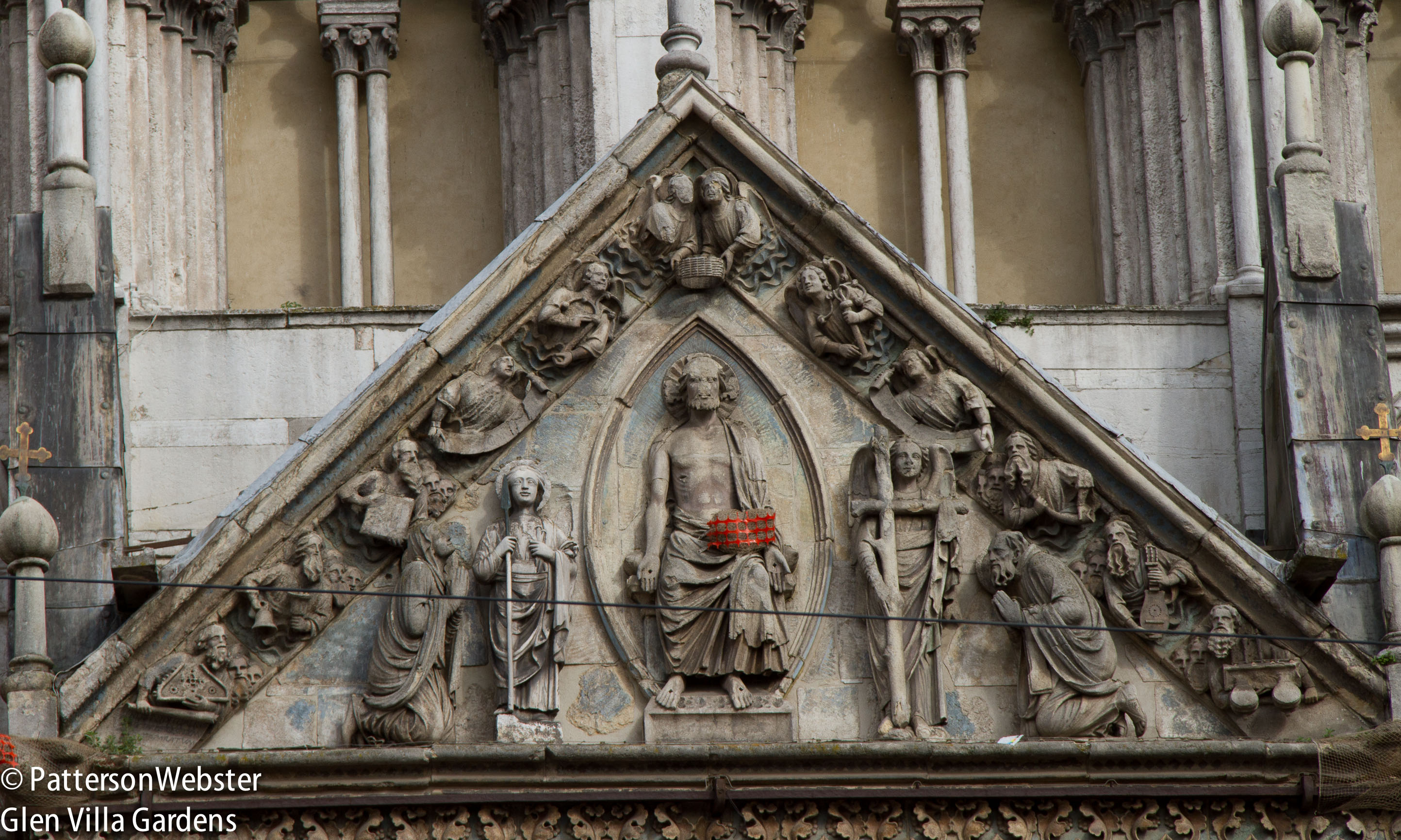 Christ is surrounded by angels. The orange mesh is protecting a vulnerable piece of stone.