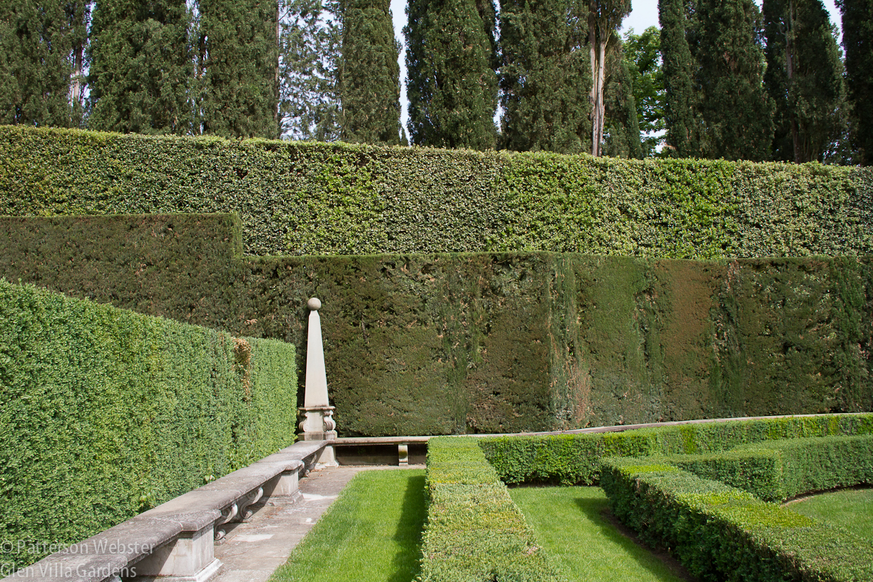 Boxwood balls and stone balls punctuate the Italian garden, along with other geometric forms.