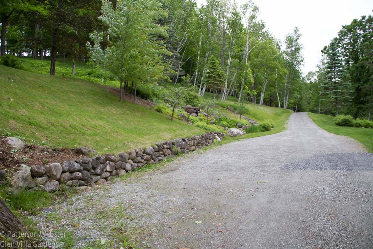 This view shows the driveway and the parking area in front of the house, out of the frame to the right. 