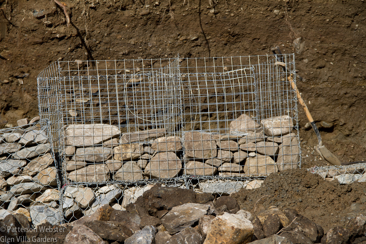 Stones partially fill two of the many gabion baskets  used in The Aqueduct.