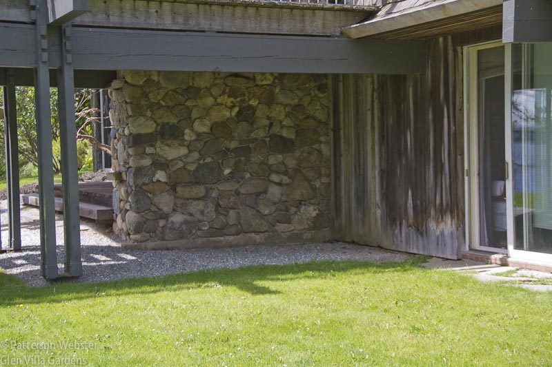 The stone wall in this photo backs onto the wooden deck. The gravel seen here connects to the Gravel Garden. So is this the place to put one more plant and several beautiful craggy rocks?  