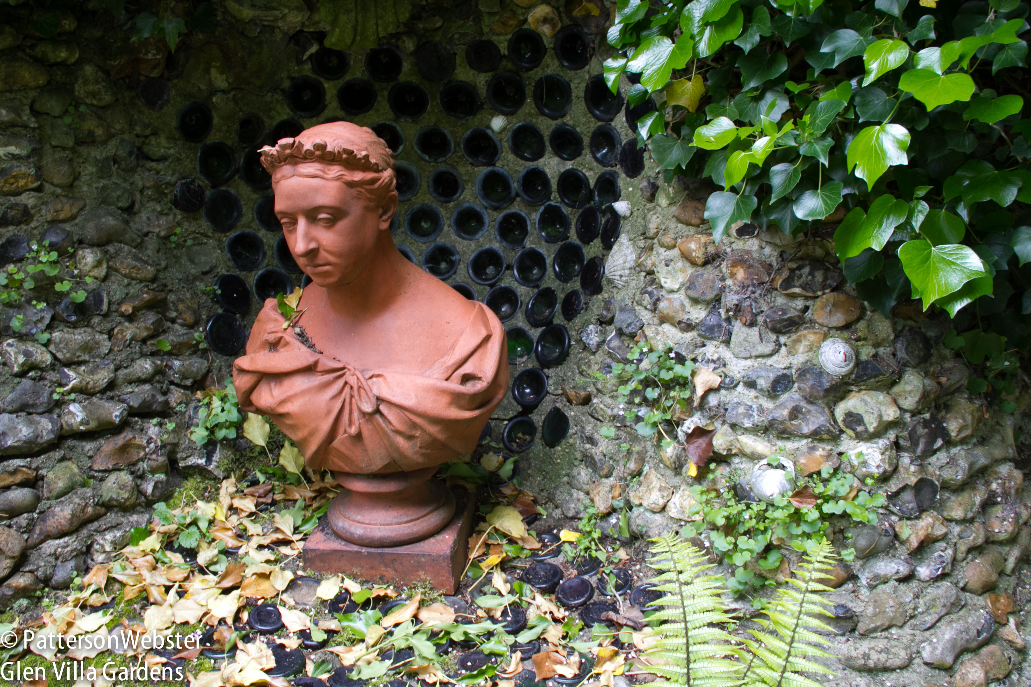 Recycled wine bottles provide a shiny backdrop to a bust of Queen Victoria at the Gibberd Garden. Does this constitute using the old with the new? 