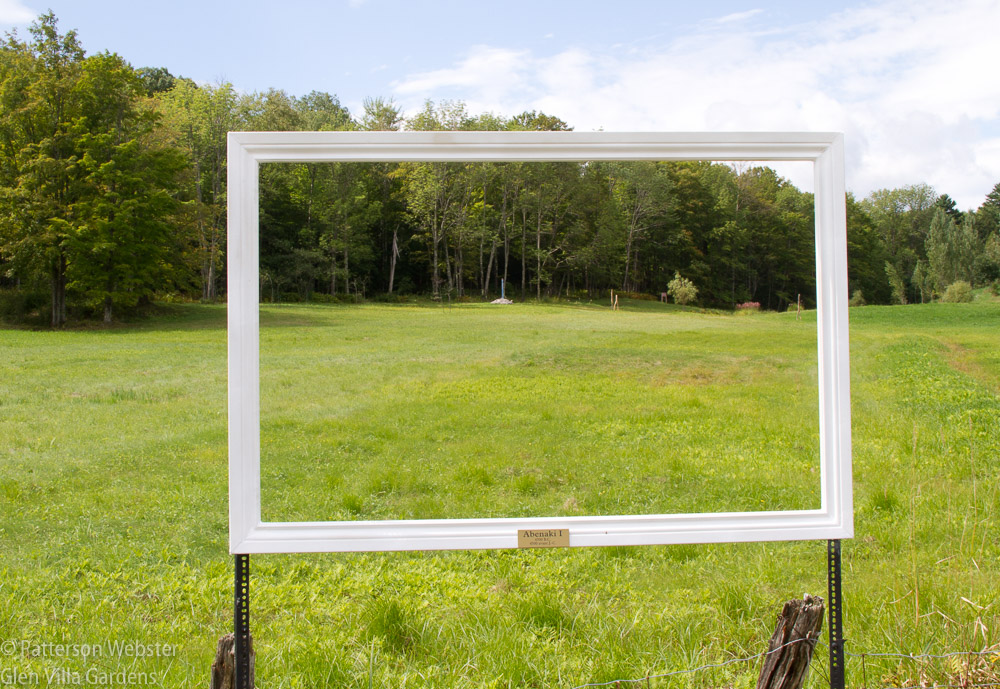 A picture frame directs people's eyes towards a distant view.