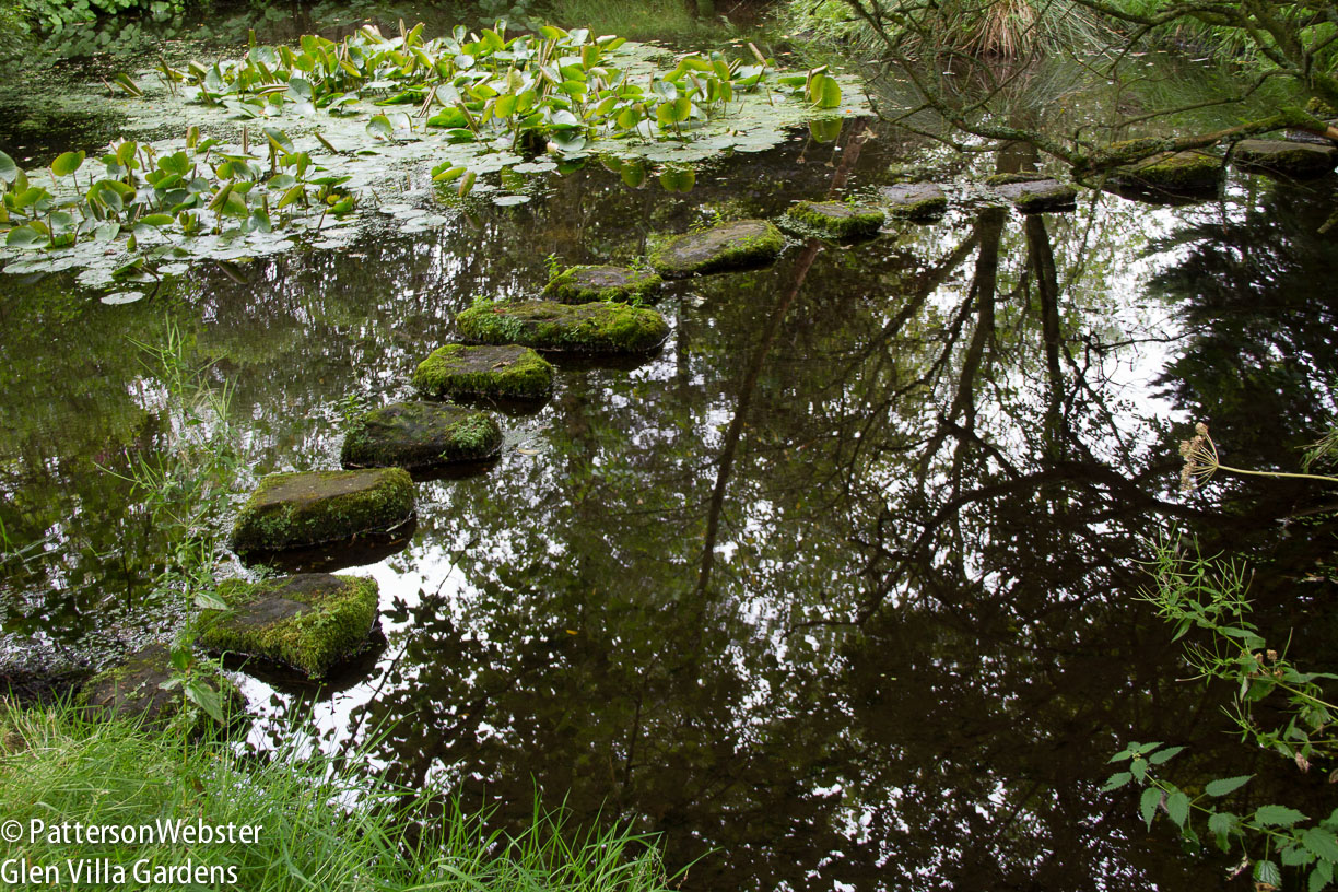 A path of stones leads across the water at Little Sparta.