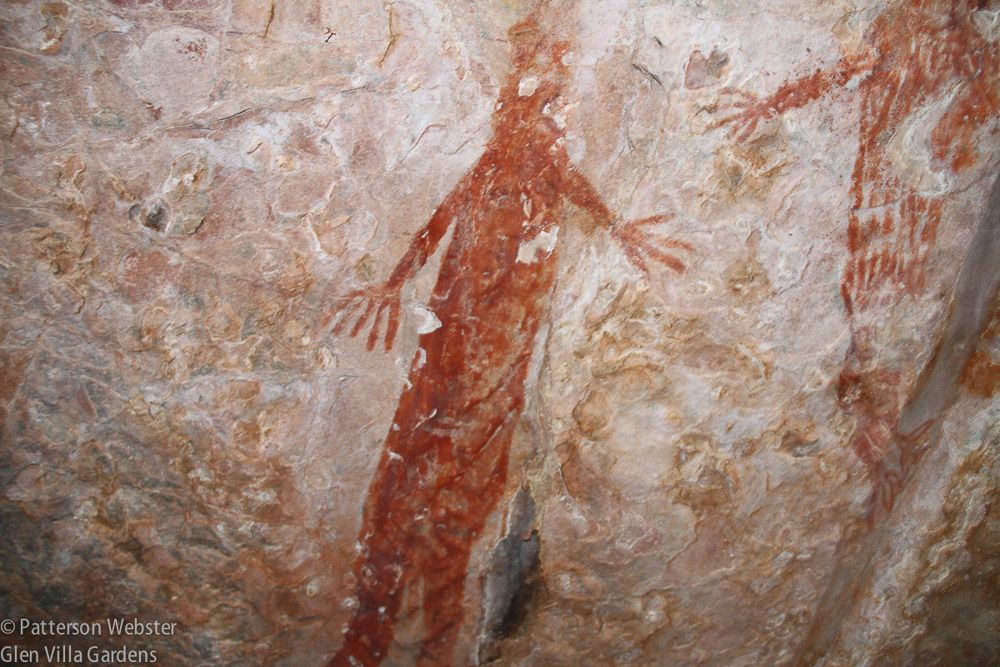 A strangely fingered figure is painted on a wall inside a cave-like overhang in the Kimberley area of West Australia.