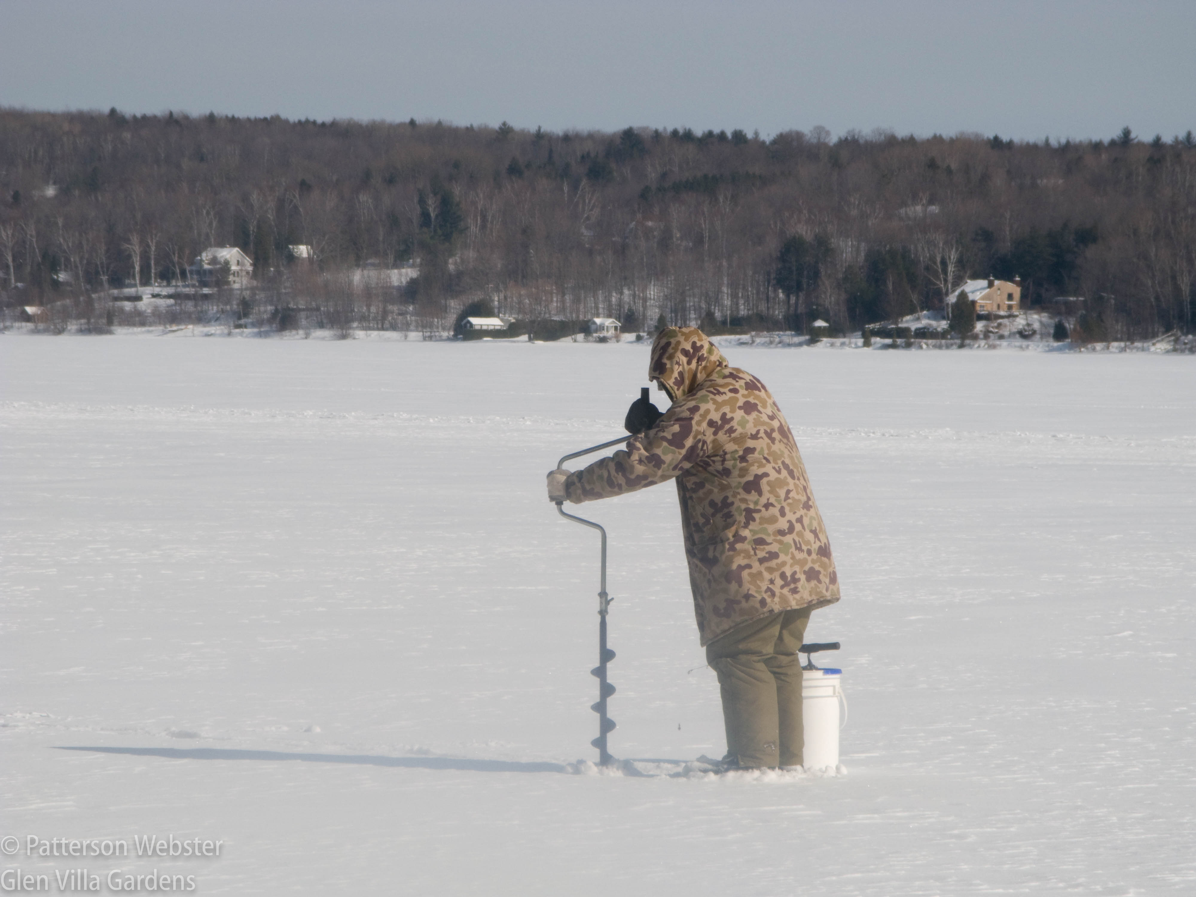 Ice fishing is most often a solitary activity. And a cold one -- this fisherman is well bundled up.