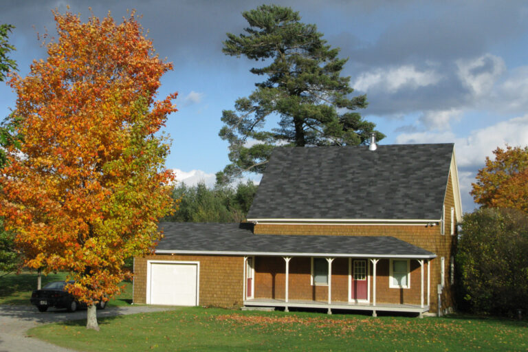 This photo dates from 2009. The house is now grey with trim that matches the red barn next to it.