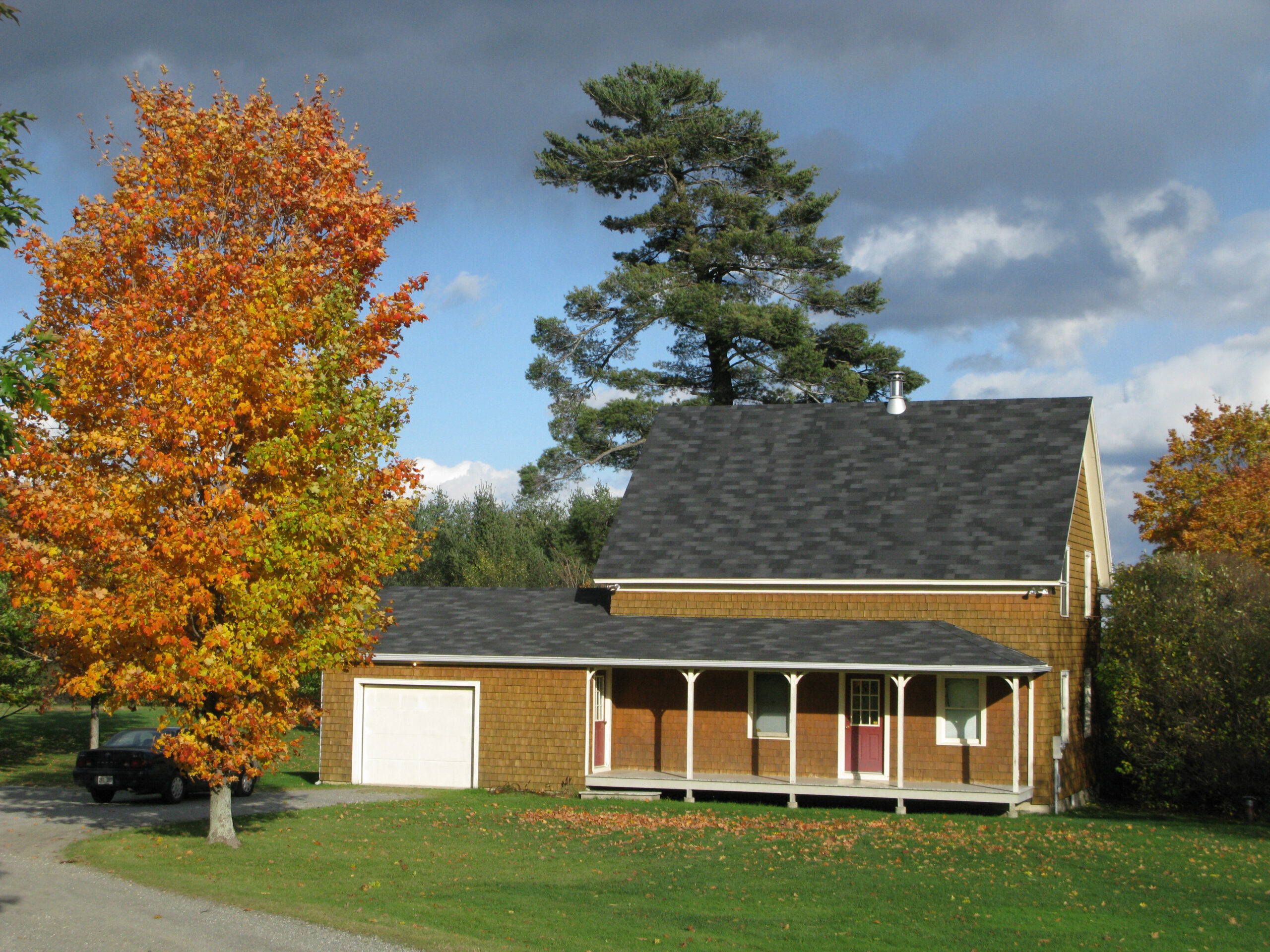 This photo dates from 2009. The house is now grey with trim that matches the red barn next to it.