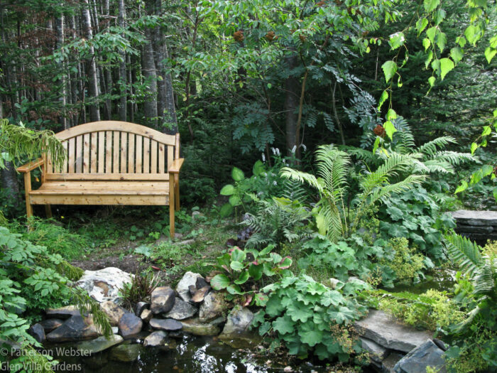 This bench from a garden in Newfoundland is next to a small pond. This bench from a garden in Newfoundland is next to a small pond.