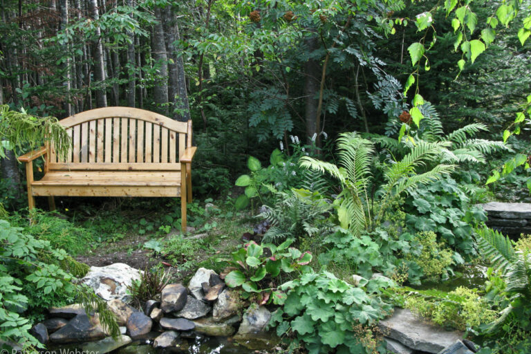 This bench from a garden in Newfoundland is next to a small pond. This bench from a garden in Newfoundland is next to a small pond.