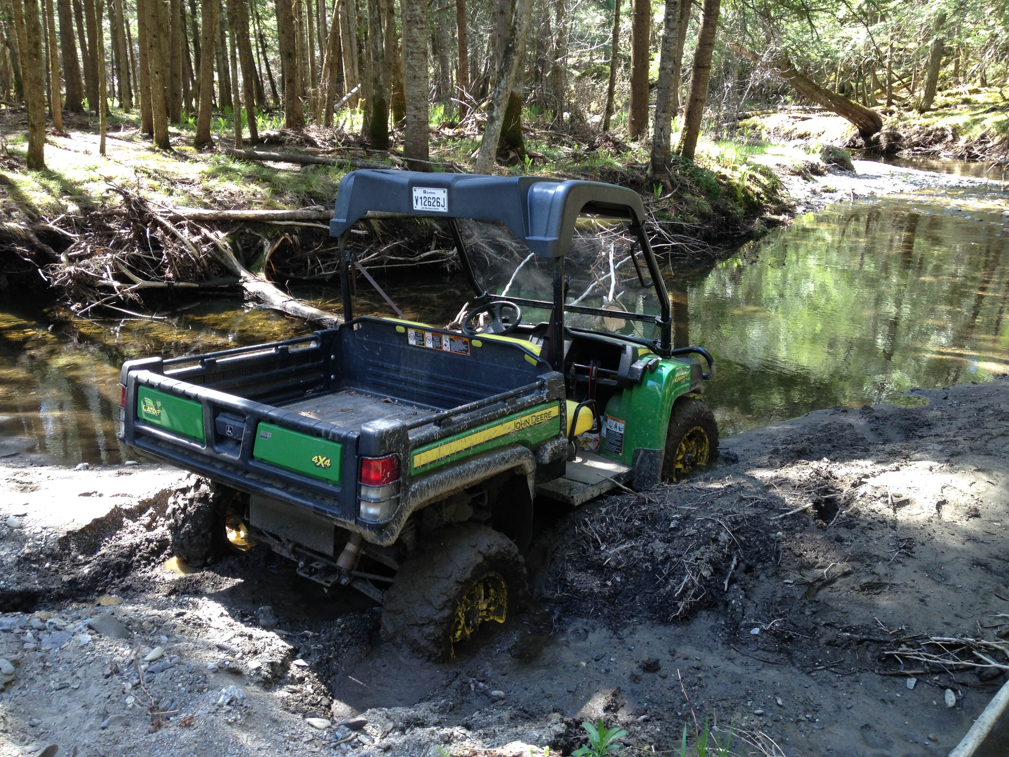 A John Deere Gator can do many things but not when it is stuck in the mud.
